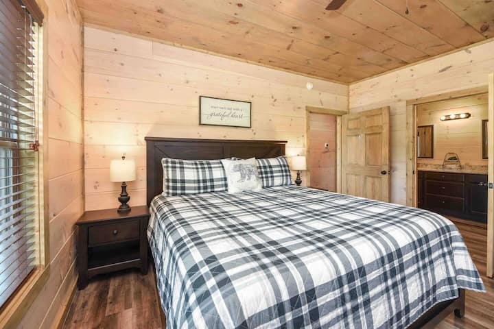 Main floor King ensuite with a smart TV, large closet, ceiling fan and attached full bathroom..