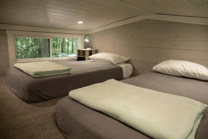 The loft features two cozy twin beds, perfect for a restful night’s sleep.