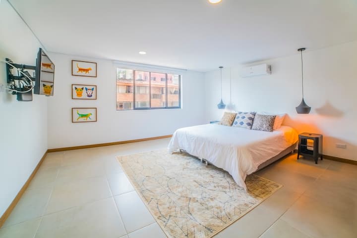 Bedroom 1 with A/C, blackout curtain, TV, closet and access to private bathroom