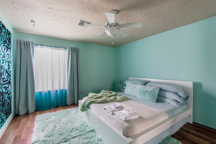 שטיח מפואר ואמנות קיר מנצנצת הופכים את חדר האקווה עם מיטת קינג סייז למקום מעולה להירגע בו.