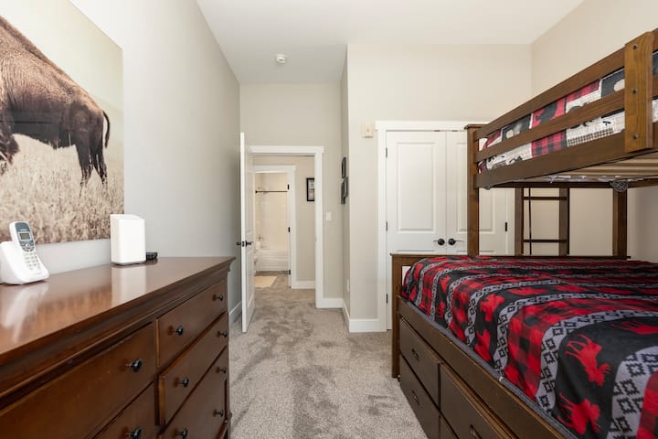 Bunk room with twin-over-queen bunk bed with twin trundle.