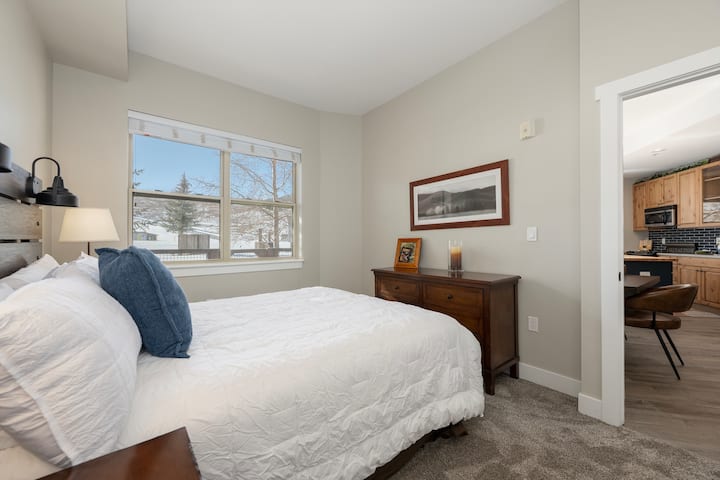 Second master suite with queen bed, ensuite bathroom, and view of slopes