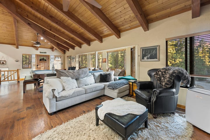 Living Room.  Sofa is West Elm sectional sleeper, with a full size mattress.  Portable window air conditioner unit upstairs (far right).  House does not have embedded AC, only heat.