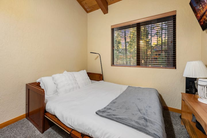 Upstairs hall bedroom.  8 ft x 7ft.  Queen murphy bed and television.  View to backyard.
