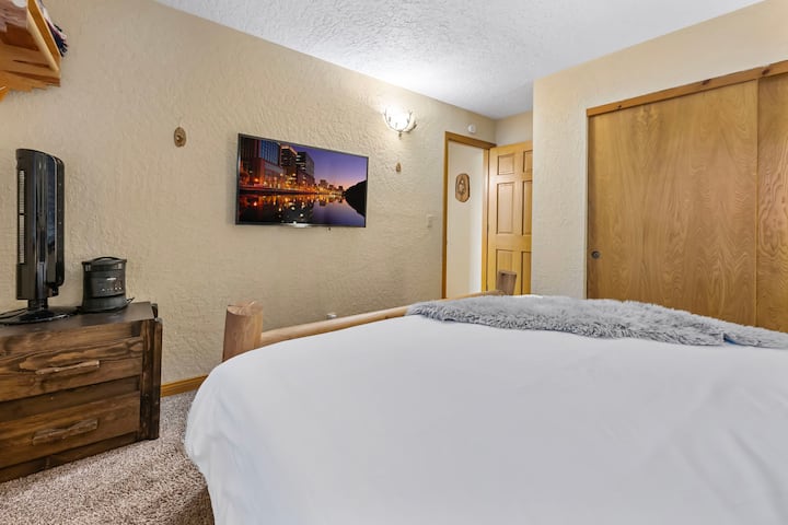 Downstairs King Bedroom #2.  Smart TV and view to backyard.