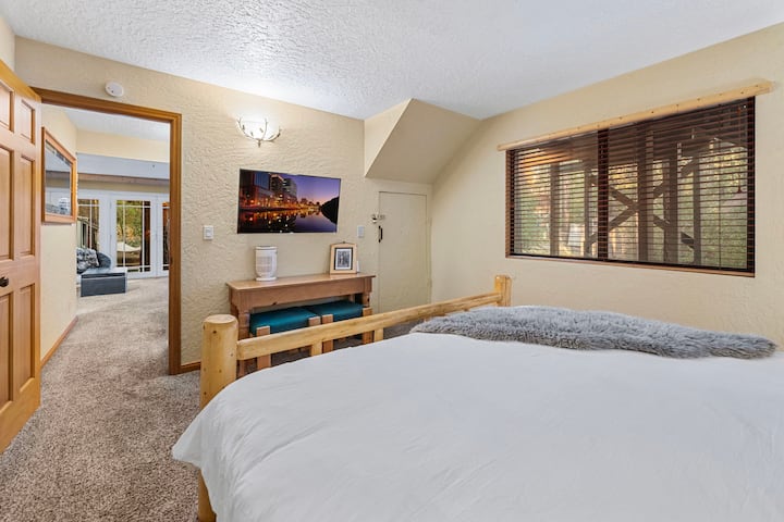 Downstairs King Bedroom #1.  Hall entrance to downstairs living room.  King Bed, smart TV