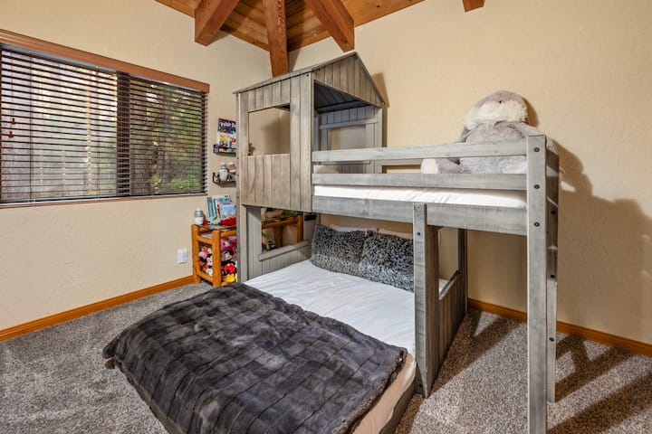 Upstairs Kids Bunk Room.  Full size bed below for adults.  Twin bunk up top for kids only.  View to backyard.  