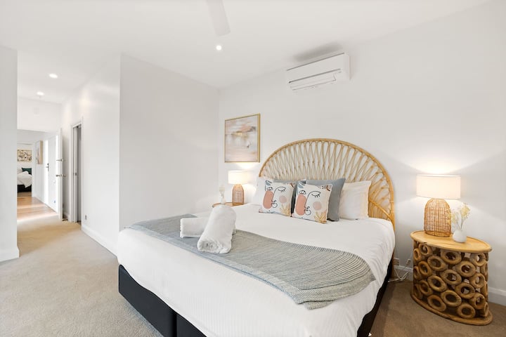 The master bedroom features a king-sized bed, TV, and black-out blinds plus ensuite bathroom and sliding doors onto the terrace with amazing views of the pool.
