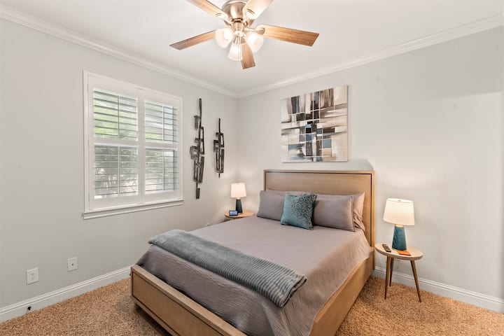 Bedroom #2 offers a serene escape with a queen-size bed and a 49-inch Smart TV—perfect for unwinding in comfort.