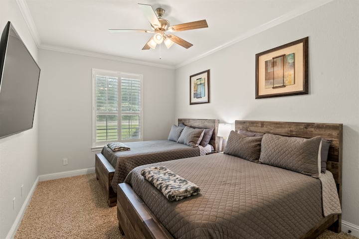 Bedroom #3: Thoughtfully designed for comfort and versatility, featuring two full-size beds and a 65-inch Smart TV—perfect for families or groups seeking refined relaxation.