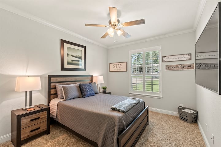 Bedroom #4: Generously sized and elegantly appointed, featuring a plush queen bed and a 65-inch Smart TV for ultimate comfort and entertainment.