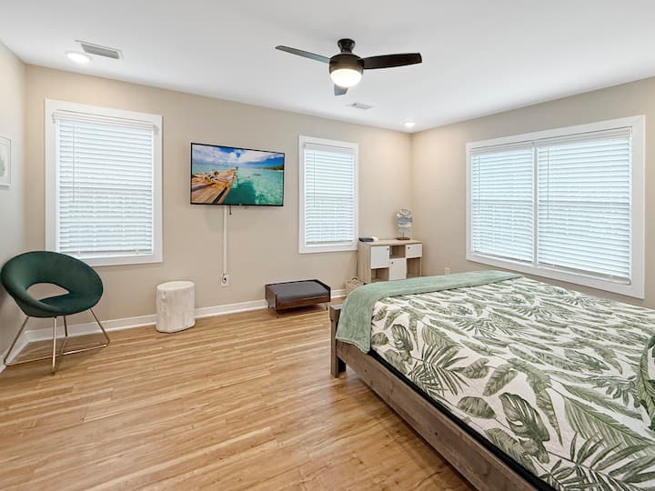 Primary bedroom with King Bed, Smart TV, ceiling fan, and pet bed