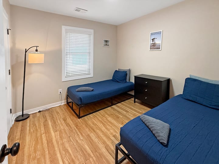 Twin guest room with modern frames, dresser and closet storage