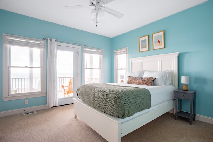Bedroom 2 features a queen bed and balcony access.