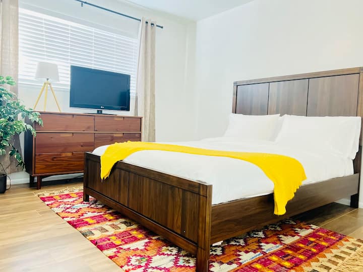Unwind in this bedroom featuring a Queen mattress adorned with luxurious Egyptian cotton linens, a spacious chest of drawers, and an HDTV for your viewing pleasure.