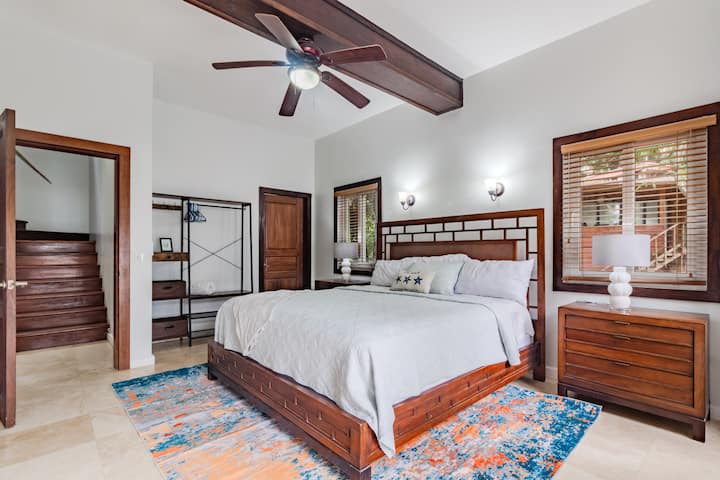 The downstairs master suite offers a spacious retreat with a comfortable king bed and a private ensuite bathroom, providing ultimate relaxation and convenience.