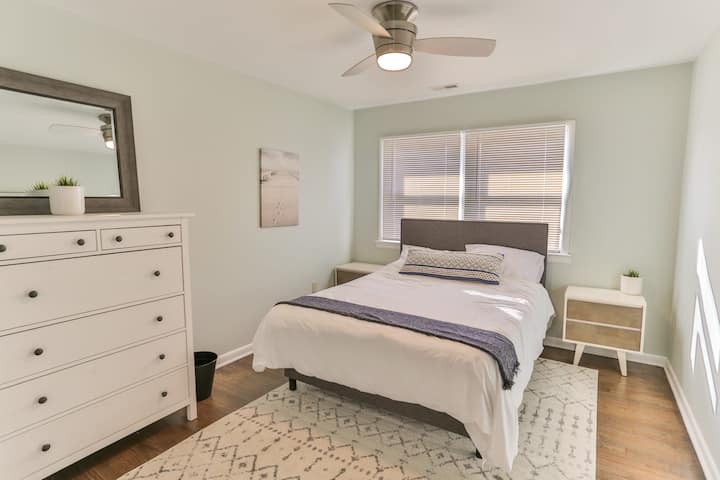 Bedroom #1 features a queen-sized bed, a dresser, a large closet, and a ceiling fan.