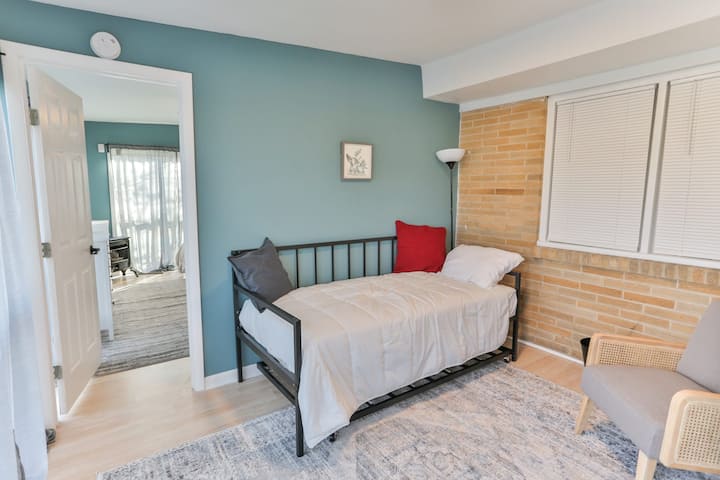 The Sitting Room is nestled between the Great Room and Bedroom #5 and looks out directly onto the water. In addition to a dresser and a comfy reading chair, there is a twin-sized daybed with a second twin-sized trundle bed underneath, perfect for a