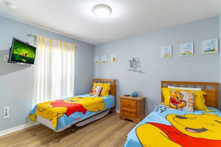 Divertida habitación Winnie The Pooh con dos camas individuales, TV de pantalla plana, suelo nuevo, pintura y ropa de cama.