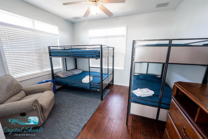 The main level bunk room has room for six with double-over-double and twin-over-twin bunks, plus a comfortable rocker to ease little ones to sleep