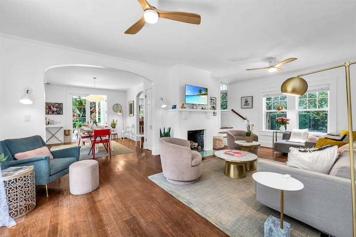 Bright and inviting living space featuring a queen and a twin sleeper sofa, a smart TV, and stylish modern fixtures. French doors open to a private outdoor patio, perfect for relaxation.