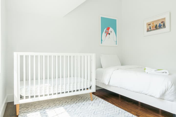 Second bedroom is on second level and includes a twin bed and crib