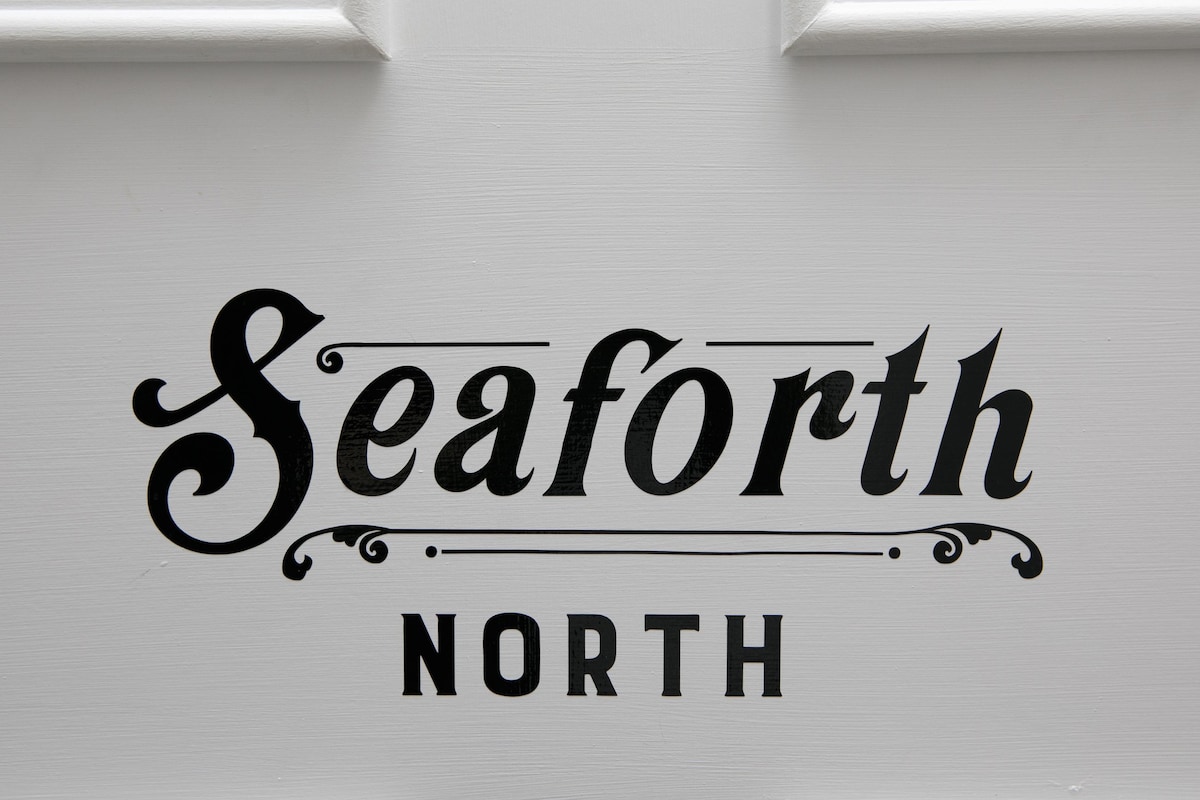A decorative sign reading 'Seaforth North' is displayed prominently, characterized by elegant lettering in black against a white background. The text features a classic font style, adding a touch of sophistication to the presentation.