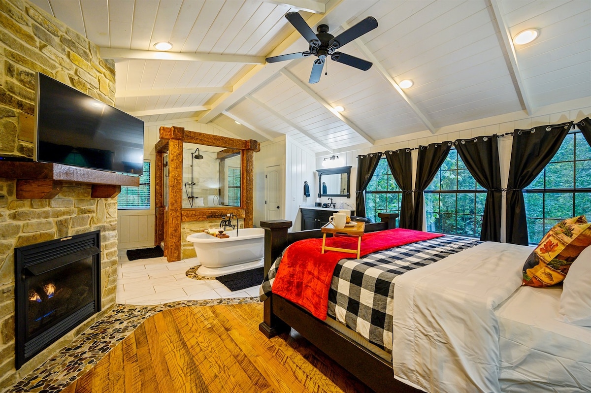 In the upstairs master suite  you can relax in your plush king bed, or soak in the tub with a good book, or shower in our  log adorned oversized shower. Decorated in a modern white black and red theme with rustic charm and large windows to take in the deer