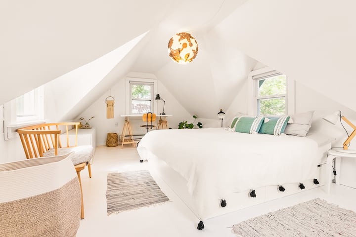 Upstairs bedroom with king-size bed and an adjustable work desk 