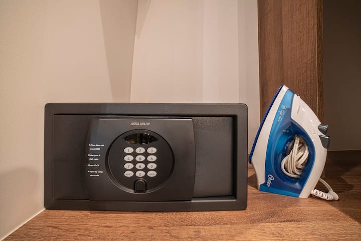 One safe deposit box bolted to the wall plus iron and board located in closet of the apartment.