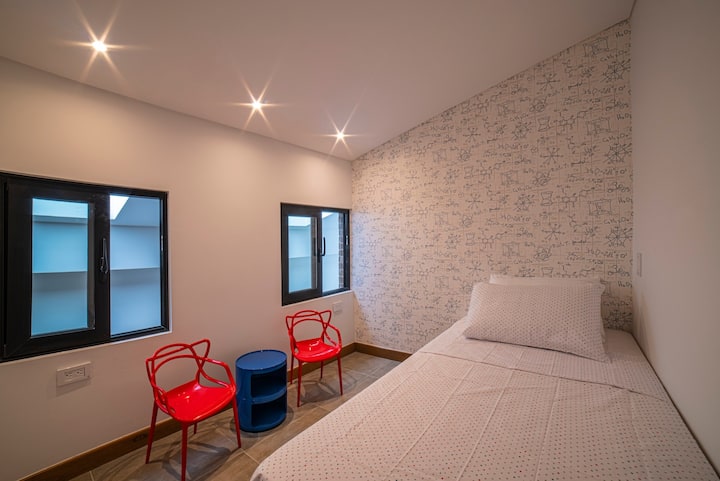 Mini bedroom on mezzanine for maximum one person. Curtains have been installed since the the picture was taken. This room does not have A/C.