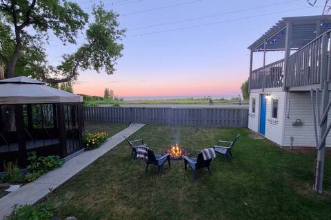 Lakefront Haven: 6BR Cottage with Hot Tub & Views