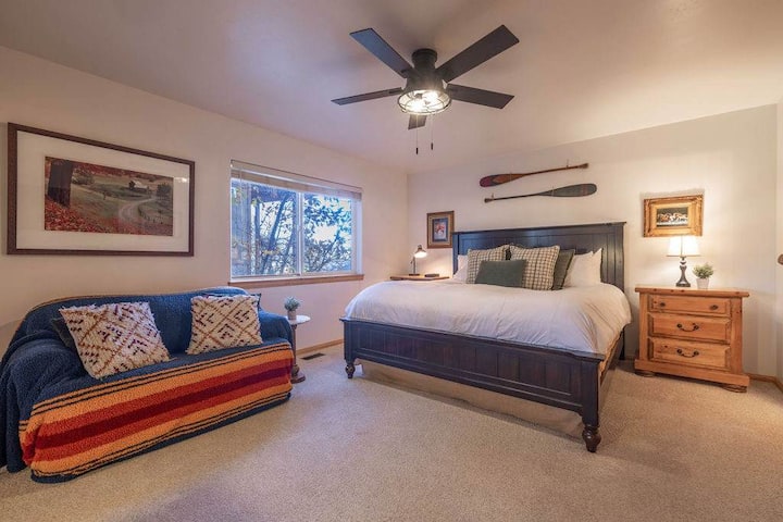 The primary bedroom has a king size bed with an en suite bathroom