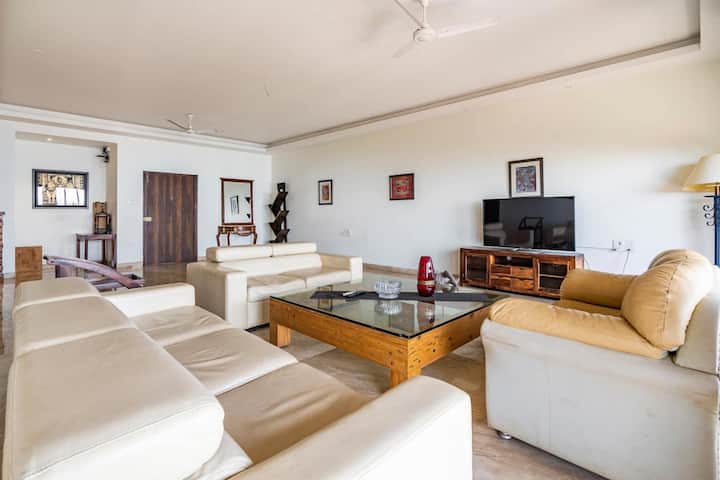 Experience unparalleled comfort in a luxurious living room, complete with elegant furniture and a private balcony offering panoramic sea views.