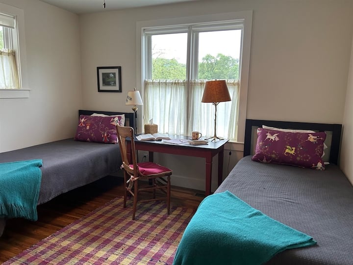 The loft bedroom features extra long twin beds & a writer's desk with good Wifi