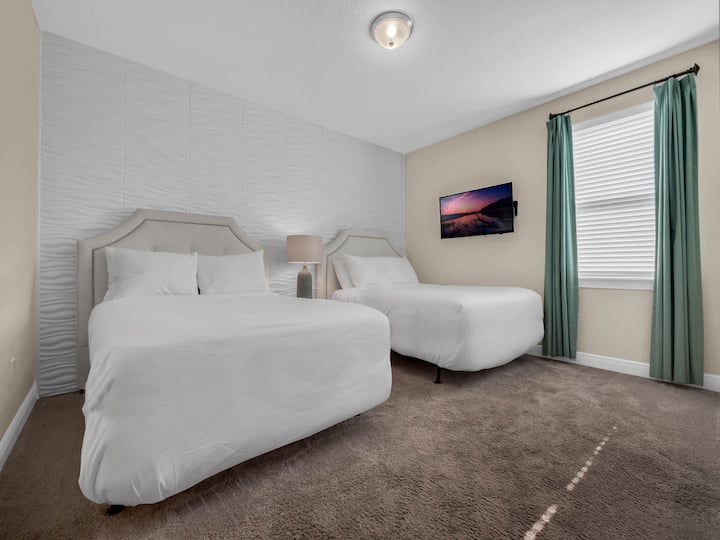 - Guest bedroom with double beds and modern decor for family vacations  
- Mounted TV and accent wall bring extra comfort for group stays  
- Ideal Orlando rental space for kids and adults in large gatherings
