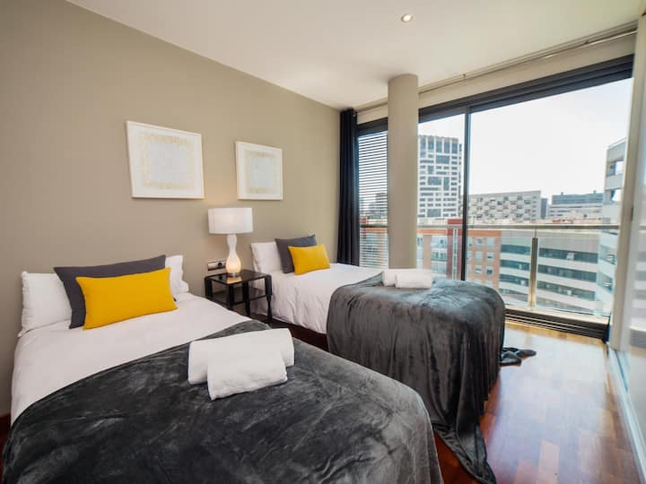 Dormitorio 2: este luminoso dormitorio ofrece dos camas individuales, un armario y acceso directo al balcón. Las ventanas del suelo al techo proporcionan mucha luz natural y hermosas vistas, creando un espacio cómodo y relajante.