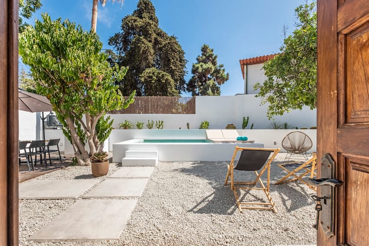 Private patio entrance with pool, dragon tree and Mediterranean garden at La Huertita de Arona