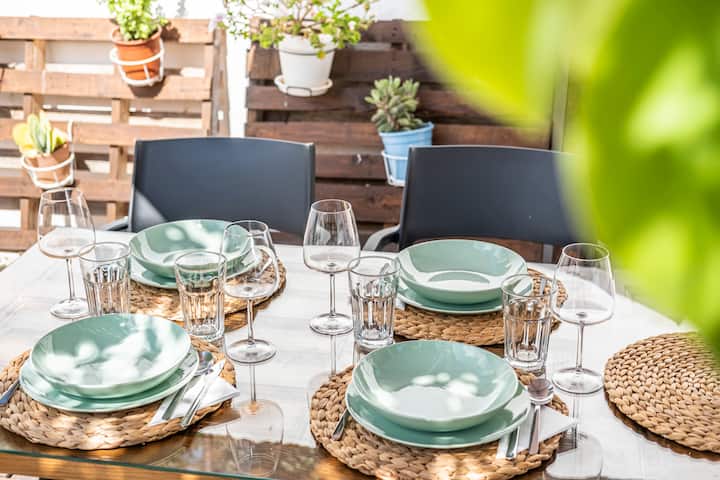 Outdoor dining table under the shade of fruit trees in the garden