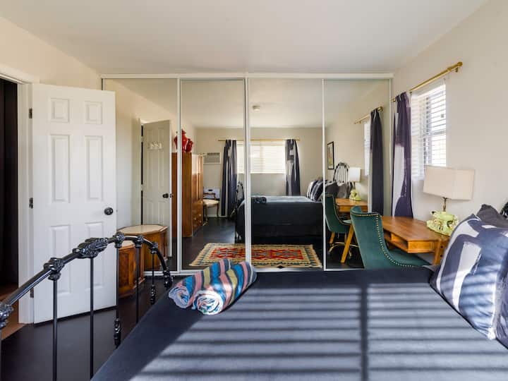 Camera da letto matrimoniale con una parete di specchi