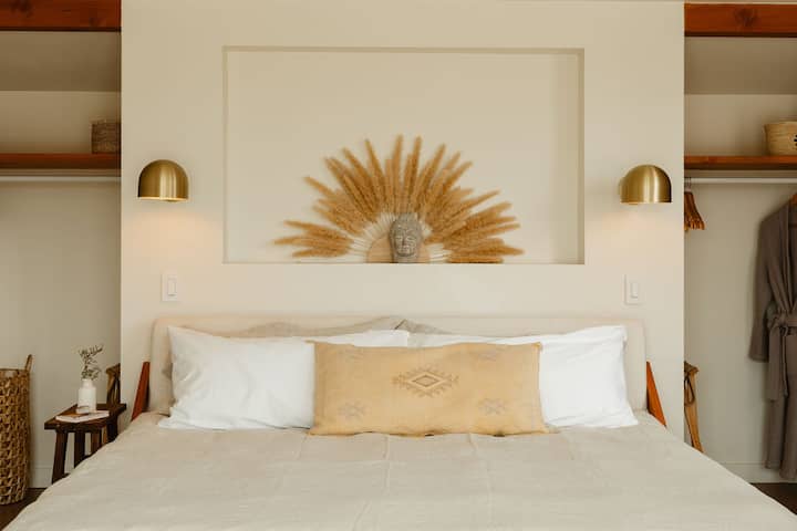 King bed with Casper Mattress and premium linens and open shelving in the Sun Bedroom