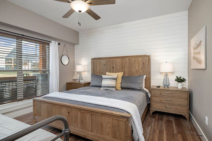 Спалня на основното ниво с двойно легло и прилежаща баня