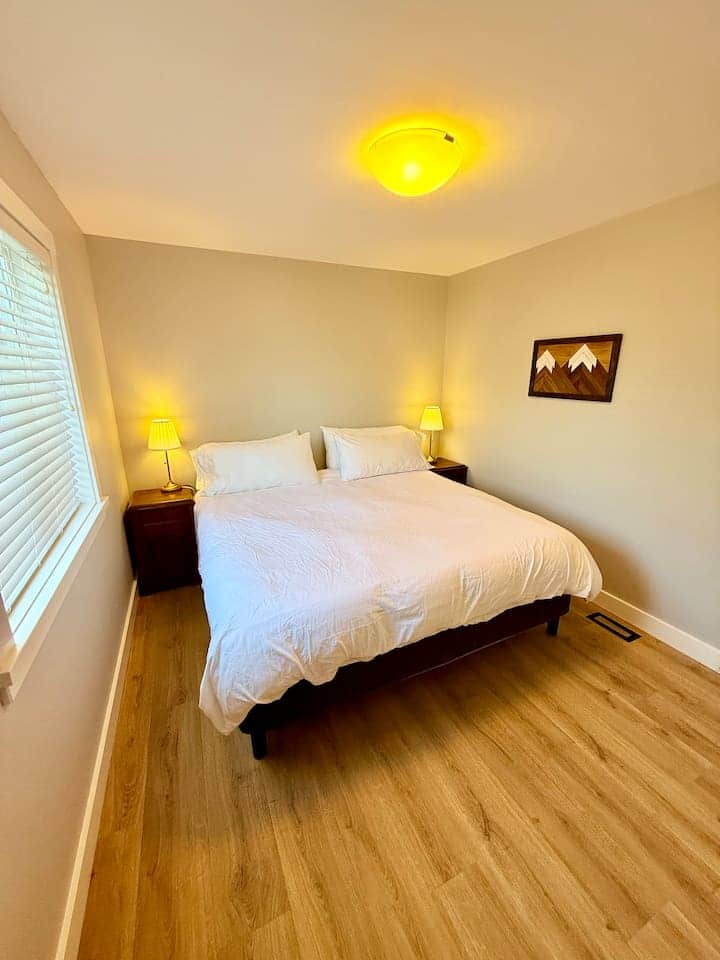 Upstairs king bedroom with bedside lamps and a simple, comfortable layout.
