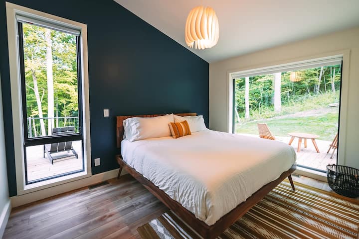 Bedroom 2.  King bed.  80 x 80 window with view of forest. Black out roller shades. 