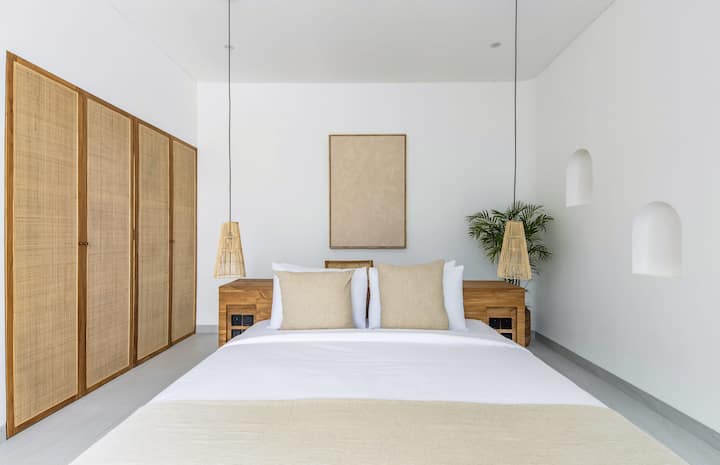 Master bedroom with a large rattan closet.