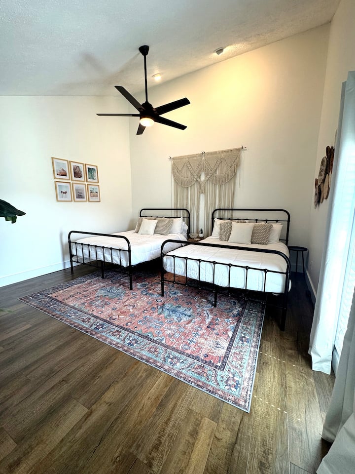 Spacious boho-chic room with two comfy beds, high ceilings and natural light