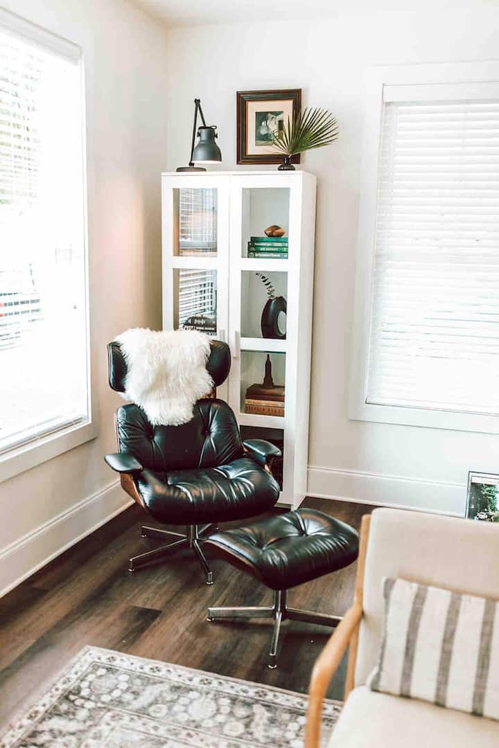 Relax in style: This inviting chair and reading corner in the living room offer a cozy retreat for unwinding with your favorite book.