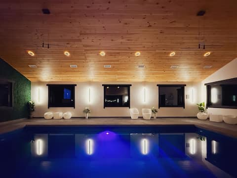 Modern indoor and outdoor pool mansion w/waterfall