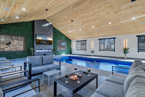 Modern indoor and outdoor pool mansion w/waterfall