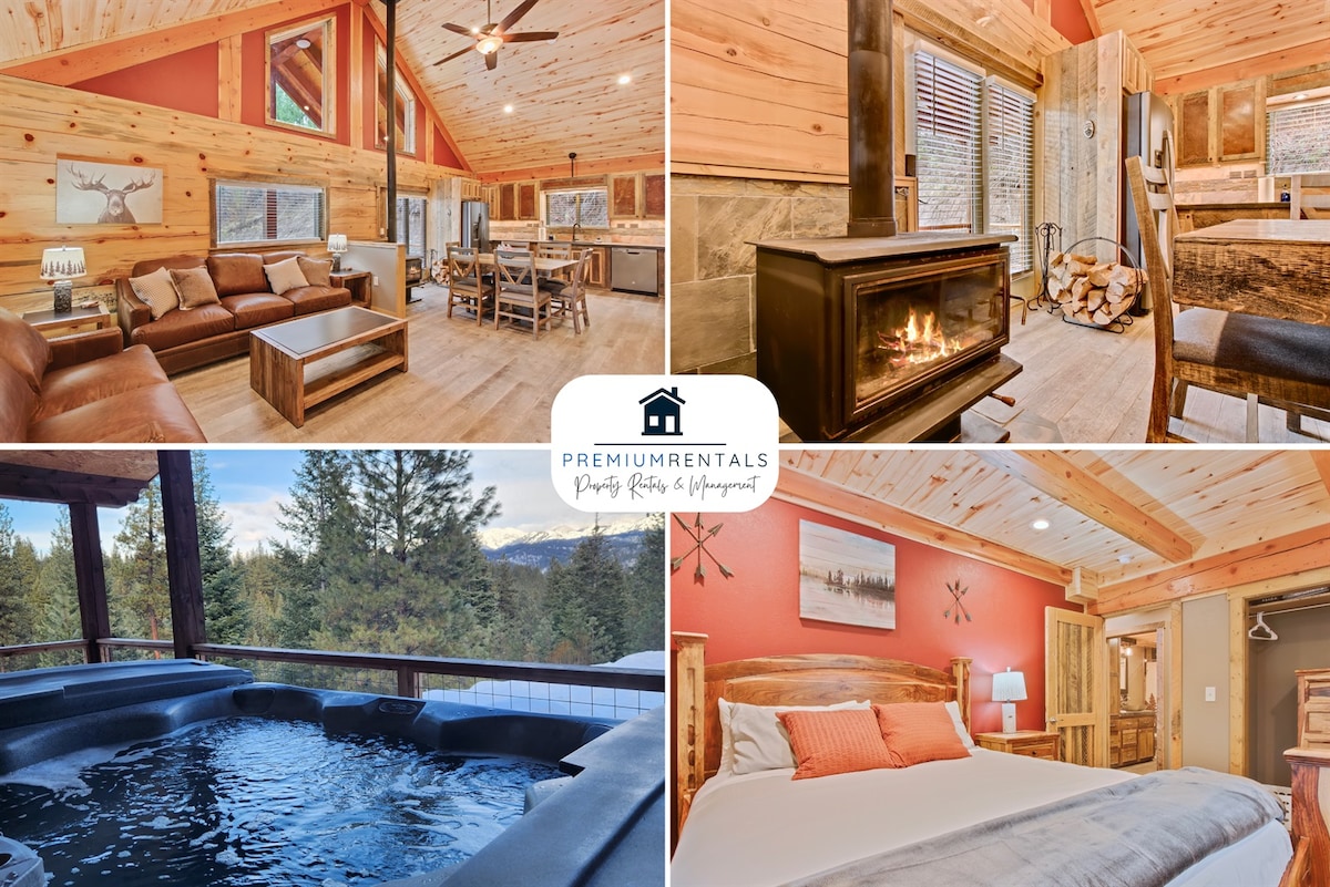 The cabin's interior blends natural wood elements with modern furnishings, featuring a comfortable leather seating area and a dining table. A cozy wood stove, surrounded by stacked firewood, adds warmth. The outdoor deck showcases a hot tub with scenic forest views, enhancing the tranquil atmosphere.